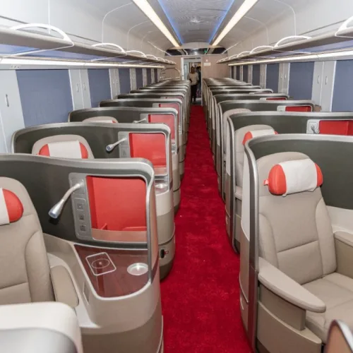 Interior of SGR first class train cabin with spacious reclining seats and aisle in Kenya